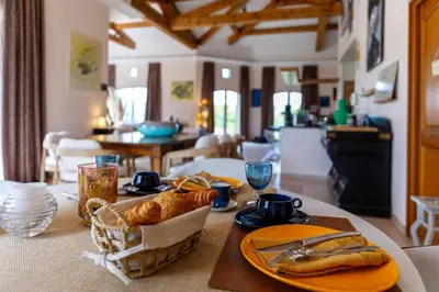 a table with food and bread on top of it at La Villa KEF - Domaine & Golf de Pont Royal in Mallemort