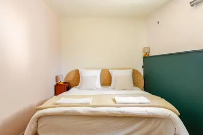 a bedroom with a large bed with two pillows at Cocoon et style - proche du centre in Aix-en-Provence