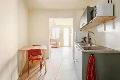 a kitchen with a sink and a table and a counter at Cocoon et style - proche du centre in Aix-en-Provence