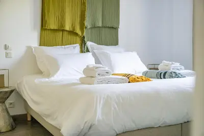 a white bed with towels on top of it at Villa Sun7 in Crillon-le-Brave