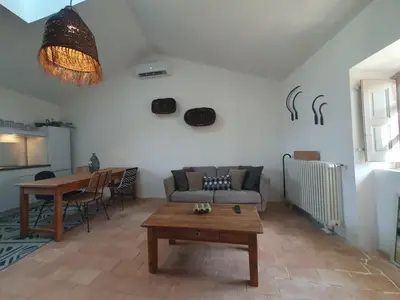 a living room with a couch and a table at Maison Grand Rue - Vue Exceptionnelle sur le Luberon in Lauris