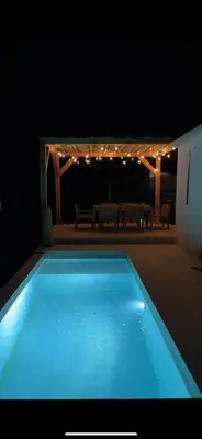 a swimming pool in the middle of a patio at night at Casa Bohemia, piscine privée proche Aix en Provence in Ventabren