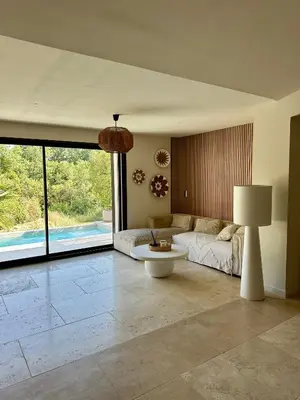 a living room with a couch and a table at Casa Bohemia, piscine privée proche Aix en Provence in Ventabren
