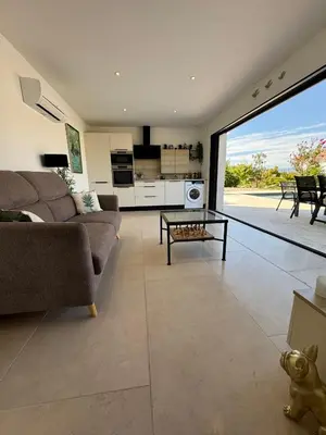 a living room with a couch and a table at Villa Cali-Provence in Le Puy-Sainte-Réparade