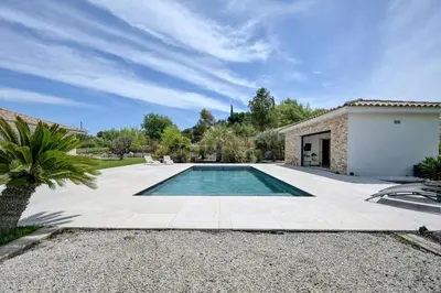 a swimming pool in a yard next to a house at Villa Cali-Provence in Le Puy-Sainte-Réparade