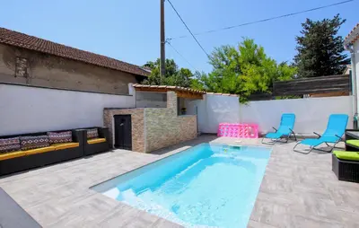a backyard with a swimming pool and two blue chairs at Awesome Home In Morières Les Avignon in Morières-lès-Avignon