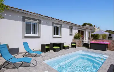 a patio with two chairs and a swimming pool at Awesome Home In Morières Les Avignon in Morières-lès-Avignon