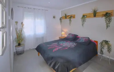 a bedroom with a bed with plants on the wall at Awesome Home In Morières Les Avignon in Morières-lès-Avignon