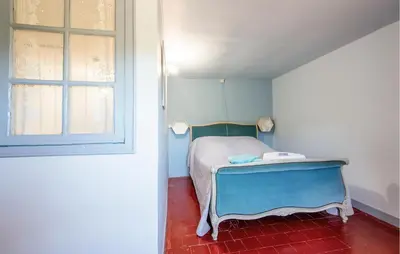 a small bedroom with a bed and a window at 3 Bedroom Stunning Home In Saignon in Saignon