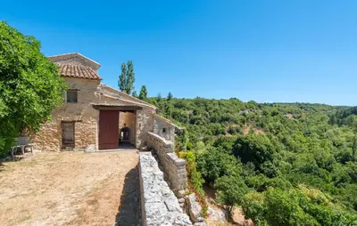an old stone house on a hill with trees at 3 Bedroom Stunning Home In Saignon in Saignon