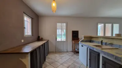 a kitchen with a counter top and a sink at La maison Calavoun in Maubec