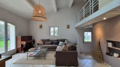 a living room with a couch and a table at La maison Calavoun in Maubec