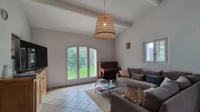 a living room with a couch and a table at La maison Calavoun in Maubec
