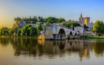 a bridge over a river in front of a city at Appartement idéal séjour touristique et pro in Vedène