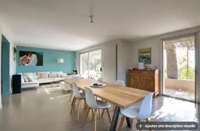 a bedroom with a large white bed with green walls at Maison et studio avec vue panoramique et piscine in La Bastidonne