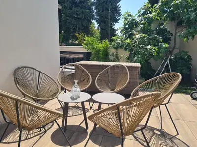 a group of chairs and a table with a vase at Villa KAMARO in LʼIsle-sur-la-Sorgue