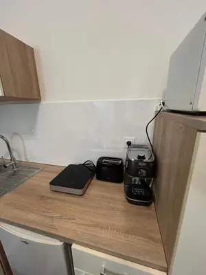 a kitchen counter with a stove and a toaster at T2 centre-ville avec parking privé inclus in Cavaillon