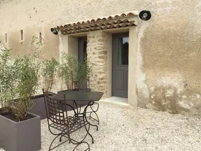 a table and chairs in front of a house at La Rivayne in Lourmarin