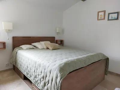 a bedroom with a large bed in a room at La Clemensane in Lacoste