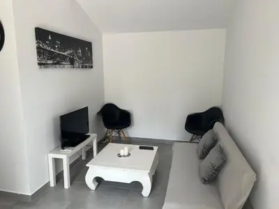 a living room with a couch and a table and a tv at Appartement T2 dans le Luberon in Cavaillon