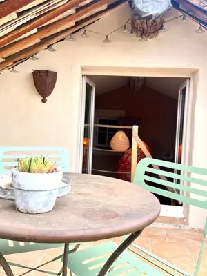 a table and chairs with a bowl of bananas on it at Authentique et paisible maison de village in Bédoin