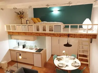 a small room with a bunk bed and a table at Studio Mezzanine Cosy in Aix-en-Provence