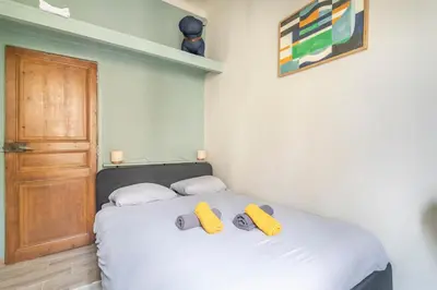 a bedroom with a bed with two yellow pillows on it at Beautiful 3 bedrooms in a detached house in Aix-en-Provence