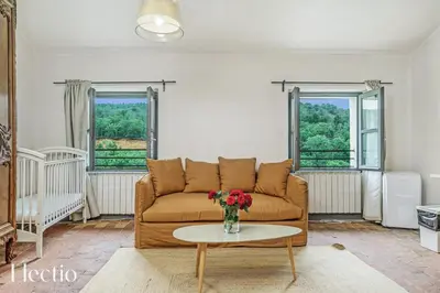 a living room with a couch and a table at Parenthèse en Luberon in Rustrel
