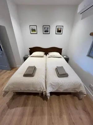 a bedroom with a large bed with two pillows on it at Bastidon provençal entièrement rénové et climatisé in Vaugines