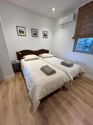 a bedroom with a bed with two towels on it at Bastidon provençal entièrement rénové et climatisé in Vaugines