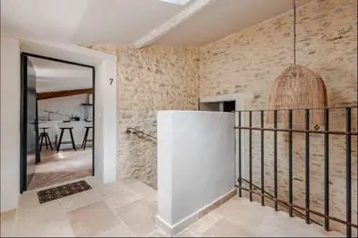 a hallway with a mirror and a dining room at Le fort 7 Appart centre ville in LʼIsle-sur-la-Sorgue