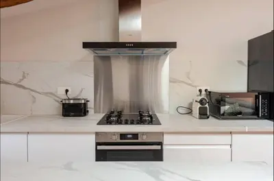 a kitchen with a stove and a counter top at Le fort 7 Appart centre ville in LʼIsle-sur-la-Sorgue