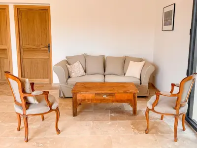 a living room with a couch and two chairs and a coffee table at Maison de charme 4 étoiles - superbe vue et bassin-piscine privé in Rustrel