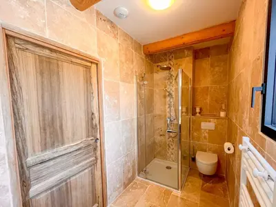 a bathroom with a shower and a toilet at Maison de charme 4 étoiles - superbe vue et bassin-piscine privé in Rustrel
