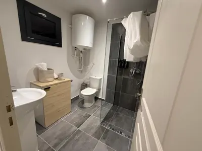 a bathroom with a shower and a toilet and a sink at Bonpas Appart Hotels in Avignon