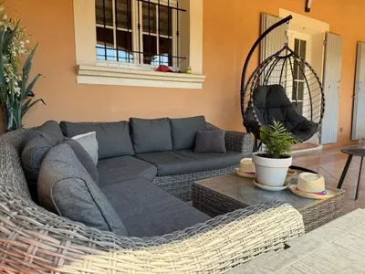 a living room with a couch and a table at Charming ground floor house with pool in Peyrolles-en-Provence