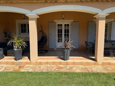 a house with potted plants on a patio at Charming ground floor house with pool in Peyrolles-en-Provence