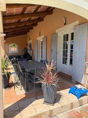 a patio with a table and chairs on a house at Charming ground floor house with pool in Peyrolles-en-Provence