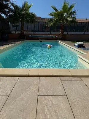 a swimming pool with a ball and a volley ball at Charming ground floor house with pool in Peyrolles-en-Provence