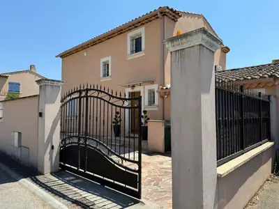 a gate in front of a house at Charming ground floor house with pool in Peyrolles-en-Provence