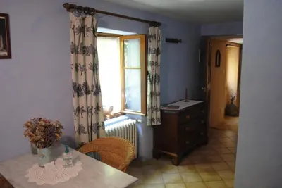 a dining room with a table and a window at Chambres d'Hôtes Istrane in Rustrel