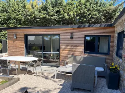 a patio with a table and chairs and a table and a table and chairs at Maison avec jaccuzzi Aix-en-Provence in Aix-en-Provence