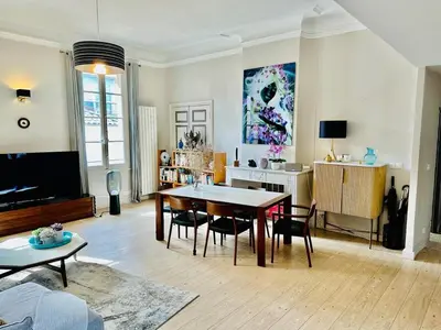 a living room with a table and chairs in it at Aix flat in historic center, 17th century building in Aix-en-Provence
