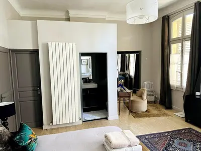 a bedroom with a large mirror in a room at Aix flat in historic center, 17th century building in Aix-en-Provence