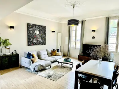 a living room with a couch and a table at Aix flat in historic center, 17th century building in Aix-en-Provence