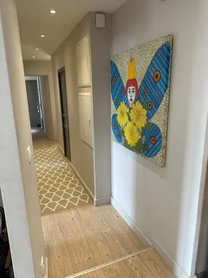 a hallway with a painting on the wall at Aix flat in historic center, 17th century building in Aix-en-Provence