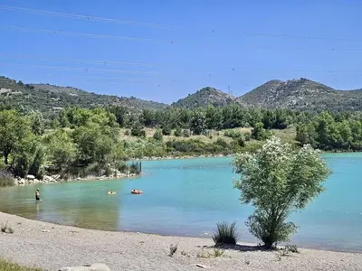 a river with people swimming in the water at Domaine Saint Roch in Saint-Paul-lez-Durance