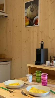 a wooden table with two plates of food on it at Cabane dans le Luberon - Bird in Provence in Cavaillon