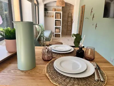 a kitchen with a wooden floor and a large window at Aix-en-Provence, Cosy studio au calme de la campagne avec Spa et Clim in Aix-en-Provence