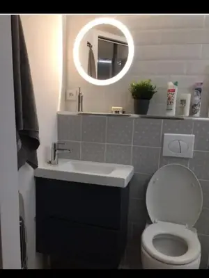 a bathroom with a sink and a toilet and a mirror at Cosy studio aix en Provence à 1 minutes du cours Mirabeau in Aix-en-Provence